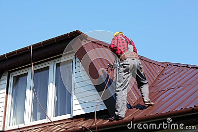 Roofer builder worker on roof Stock Photo