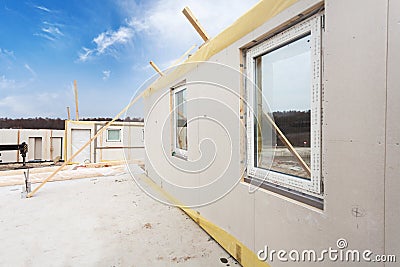 Roofer builder workers with crane installing structural Insulated Panels SIP. Building new frame energy-efficient house. Stock Photo