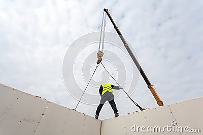 Roofer builder workers with crane installing structural Insulated Panels SIP. Building new frame energy-efficient house. Stock Photo