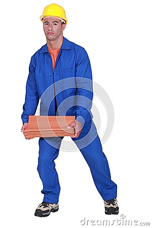 Roofer carrying tiles roof. Stock Photo