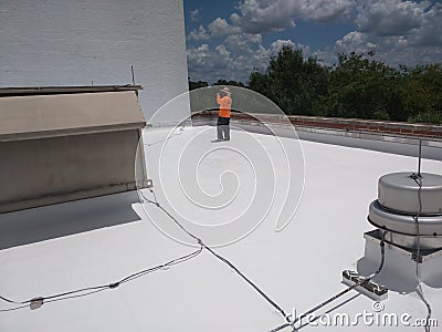 Roofer inspecting a commercial flat roof, EPDM Roofing Editorial Stock Photo