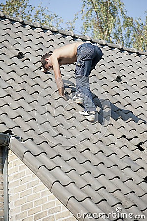 Roofer working on a roof Stock Photo