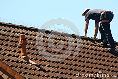 Roofer is working on a roof Editorial Stock Photo