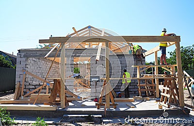 Roofers Building Wood Trusses Roof Frame House Construction. Roofing construction Stock Photo