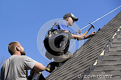 Roofers on a Steep Pitch Editorial Stock Photo