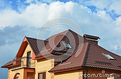 Roofing construction with attic skylights, rain gutter system, roof windows and roof protection from snow snow guard house Stock Photo