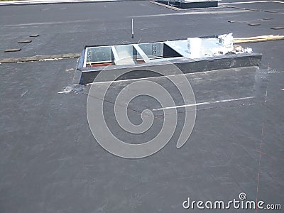 View of Roofing repairs; AC curb on Commercial EPDM flat roof Editorial Stock Photo