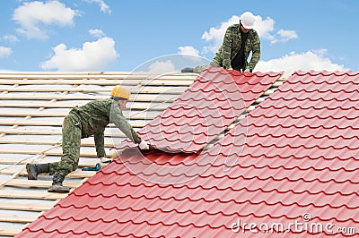 Roofing work with metal tile Stock Photo