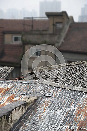 Roofs with tiles and rusty corrugated iron in rough old traditional part of Chinese city Stock Photo
