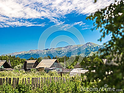 Roofs of traditional houses seen behind the fence and gardens Stock Photo