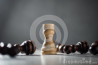 Rook standing among fallen pawns, immunity and resilience concept. Stock Photo