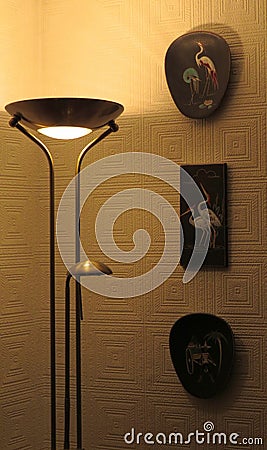 Room corner with uplighter and wall plaques. Stock Photo