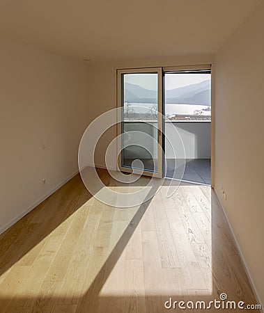 The room has white walls and wooden floors Stock Photo