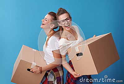 Roommates with a cardboard boxes and standing back to back Stock Photo