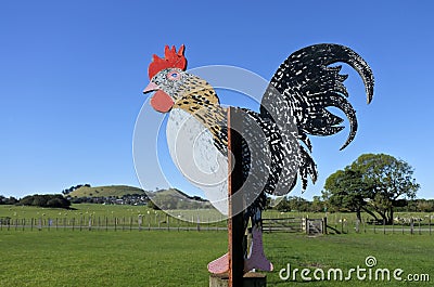 Rooster on a fence of a chicken farm Stock Photo