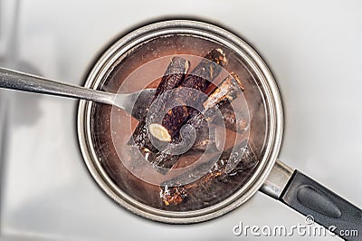 Roots boiling in a saucepan. Stock Photo