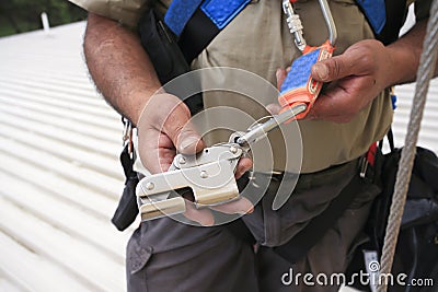 Rope access construction worker inspection maintenance services on safety equipment device Stock Photo