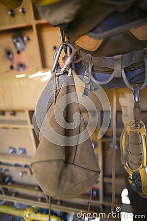 Rope access equipment accessories brawn tool bag hanging on the side of inspector abseiler safety harness loop Stock Photo