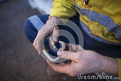 Rope access inspector hand commencing daily safety checking inspecting locking Carabiner defective equipment Stock Photo