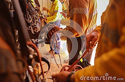 Rope access technicians inspecting gear and fasten figure of eight knot with 10.5 mm static rope Stock Photo