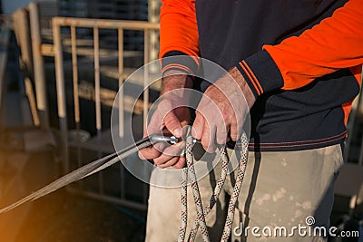 Rope access worker inspector inspecting rope rigging tie with safety bunny ears knot prior to used Stock Photo