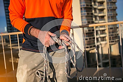 Rope access worker inspector inspecting rope rigging tie with safety bunny ears knot prior to used Stock Photo