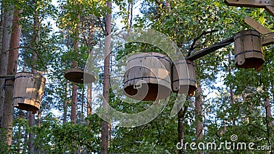 Rope adventure park in the summer forest. Abstract concept Overcoming obstacles and reaching heights Stock Photo