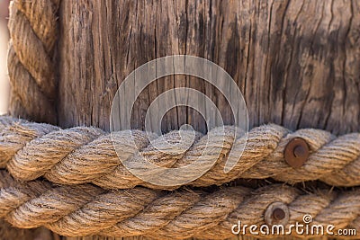 Rope around wood pillar nautical ship object, wooden background texture Stock Photo