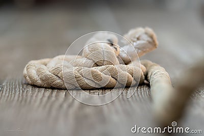 a rope is being rolled up on a table top with its knot exposed Stock Photo