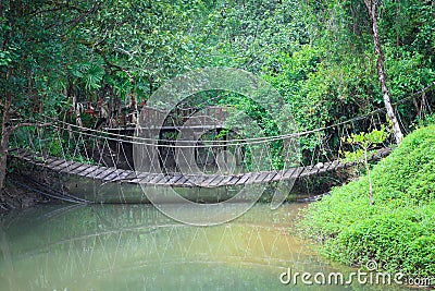 Rope bridge across river Stock Photo