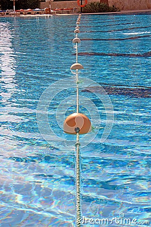 Rope with floats lies in the pool clear water Stock Photo
