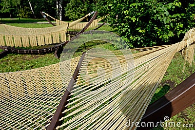 Rope hammocks on wooden supports in the park Stock Photo