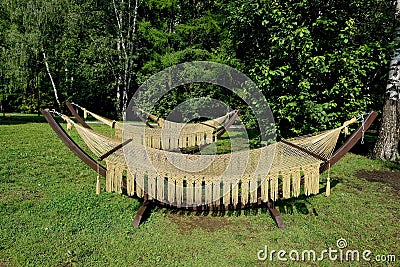 Rope hammocks on wooden supports in the park Stock Photo