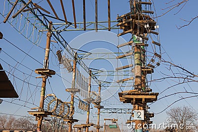 Rope obstacle track high in the trees in adventure park. Rope park Stock Photo