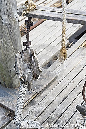 The rope on the rafter of an old wooden ship. Stock Photo