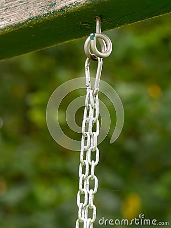 Rope ring knot hanging on wooden beam, trees in background Stock Photo