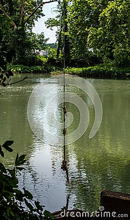 Rope swing over the waters Stock Photo