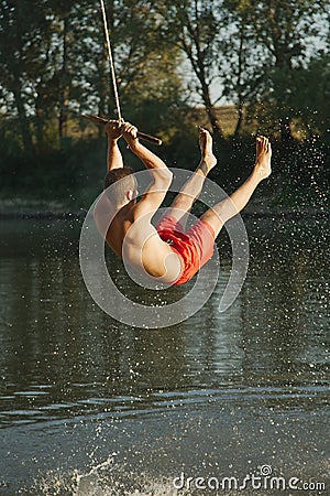 Rope swing river jump Stock Photo