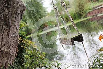 Swing by river Stock Photo