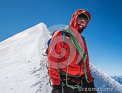 Rope team happy smiling man in climbing harness dressed red mountaineering clothes Last steps before Mont Blanc Monte Bianco Stock Photo