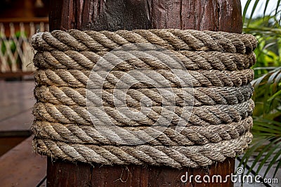 Rope tie on wood pillar Stock Photo