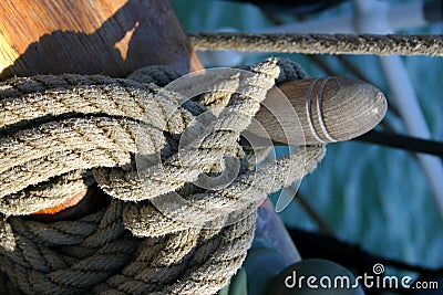 Rope tied around wooden cleat Stock Photo