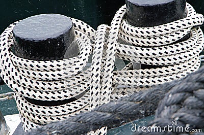 2 ship bollards with lashed ropes Stock Photo