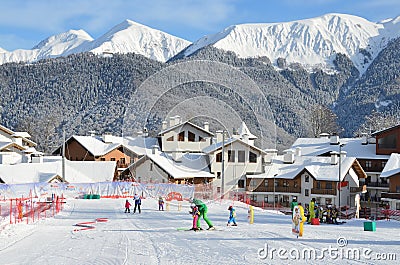 Rosa Khutor, Sochi, Russia, January, 26, 2018. Instructor and little boy skiing on the child`s training slope in the background of Editorial Stock Photo