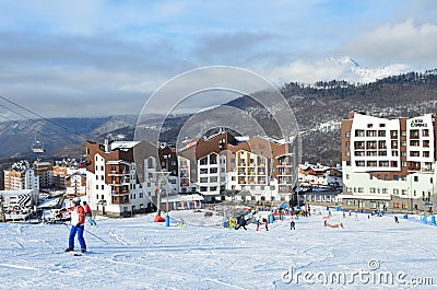 Rosa Khutor, Sochi, Russia, January, 26, 2018, People skiing near hotel `Rosa Skinn` in Olympic village on Rosa Khutor ski resort Editorial Stock Photo