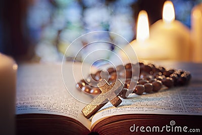 Rosary beads and crucifix cross on holy bible Stock Photo