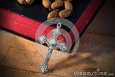 Rosary Beads and Holy Bible on Wooden Table Stock Photo