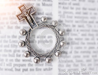 Rosary, open book or bible study for faith, studying religion or mindfulness with holy spiritual scripture. Christian Stock Photo