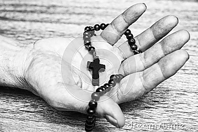 Rosary in open hand Stock Photo