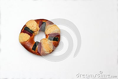 The roscÃ³n, rosca de Reyes or king cake, a torus-shaped sweet dough bun decorated with slices of candied or crystallized fruit Stock Photo
